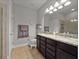 Bathroom featuring glass shower, granite counter with double sinks, and neutral tile flooring at 3675 Cabo Ln, St Cloud, FL 34772