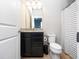 Bathroom featuring granite counters, dark wood cabinets, and a shower with a striped curtain at 3675 Cabo Ln, St Cloud, FL 34772