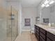 Bathroom featuring glass shower, granite counter with double sinks, and neutral tile flooring at 3675 Cabo Ln, St Cloud, FL 34772