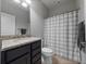 Bathroom featuring granite counters, dark wood cabinets, and a shower with a patterned curtain at 3675 Cabo Ln, St Cloud, FL 34772