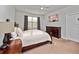 This bedroom features a ceiling fan, a window for natural light, and attractive wooden furniture at 3675 Cabo Ln, St Cloud, FL 34772