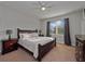 This bedroom features a ceiling fan, a window for natural light, and is fully furnished at 3675 Cabo Ln, St Cloud, FL 34772