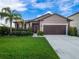Charming single-story home featuring a well-manicured lawn and a lovely palm tree at 3675 Cabo Ln, St Cloud, FL 34772