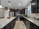 Kitchen featuring granite counters, stainless appliances and dark wooden cabinets at 3675 Cabo Ln, St Cloud, FL 34772