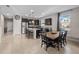 Open-concept kitchen with island seating flows into the dining area at 3675 Cabo Ln, St Cloud, FL 34772