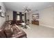 Inviting living room featuring a large leather sectional, neutral tile flooring, and sliding glass doors at 3675 Cabo Ln, St Cloud, FL 34772