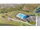 Aerial view of a community pool, playground, and surrounding green space with sidewalks at 3675 Cabo Ln, St Cloud, FL 34772