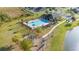 Aerial view of the community pool, playground and cabana area surrounded by landscaping at 3675 Cabo Ln, St Cloud, FL 34772