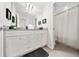Bathroom with dual granite vanity, white cabinets, and a shower/tub combination at 4002 Lana Ave, Davenport, FL 33897