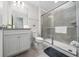 Clean bathroom featuring granite vanity, tile floors, and glass enclosed shower at 4002 Lana Ave, Davenport, FL 33897