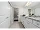 Well-lit bathroom features double granite vanity, white cabinets and a separate shower at 4002 Lana Ave, Davenport, FL 33897