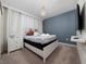 A well-appointed bedroom with a statement wall and soft lighting offers a peaceful ambiance at 4002 Lana Ave, Davenport, FL 33897