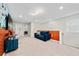 Cozy upstairs bonus room featuring neutral carpet and a comfortable blue sofa at 4002 Lana Ave, Davenport, FL 33897