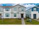 Charming townhome with a well-manicured lawn and welcoming entrance showcases the exterior of the home at 4002 Lana Ave, Davenport, FL 33897