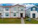 Charming townhome with a well-manicured lawn and welcoming entrance showcases the exterior of the home at 4002 Lana Ave, Davenport, FL 33897