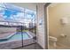 Screened-in pool area with patio, featuring a half bathroom accessible from the outside at 4002 Lana Ave, Davenport, FL 33897