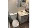 Bright bathroom with a single sink vanity, updated fixtures, and tile flooring at 414 Dakota Ave, St Cloud, FL 34769