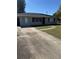 Lovely home with long driveway and well-maintained lawn leading up to the front door at 414 Dakota Ave, St Cloud, FL 34769