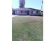 Charming single-story home with a well-kept lawn, neutral paint, and a paved walkway at 414 Dakota Ave, St Cloud, FL 34769