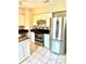 Spacious kitchen with stainless steel appliances, white cabinets, and a tile backsplash at 414 Dakota Ave, St Cloud, FL 34769
