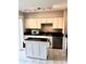 Updated kitchen with black countertops, white cabinets, and stainless steel appliances at 414 Dakota Ave, St Cloud, FL 34769