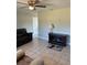 Comfortable living room with tile floors, a ceiling fan, and space for relaxation at 414 Dakota Ave, St Cloud, FL 34769