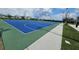 This outdoor basketball court is complete with blue court and hoops for recreational play at 4497 Bluff Oak Loop, Kissimmee, FL 34746