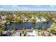 Beautiful aerial view of a serene lake surrounded by lush trees and charming homes, showcasing the neighborhood at 4531 Lake Trudy Dr, St Cloud, FL 34769