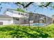 Lush backyard with a sparkling pool, screened enclosure, and a well-maintained lawn at 4531 Lake Trudy Dr, St Cloud, FL 34769