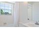 Light-filled bathroom features a vanity, toilet, and tiled shower at 4531 Lake Trudy Dr, St Cloud, FL 34769
