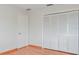 Bright bedroom featuring hardwood floors, closet, and white trim at 4531 Lake Trudy Dr, St Cloud, FL 34769