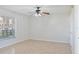 A light-filled bedroom with neutral paint, tile floors, and a ceiling fan at 4531 Lake Trudy Dr, St Cloud, FL 34769