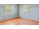 Inviting bedroom features hardwood floors, two sunny windows and neutral walls at 4531 Lake Trudy Dr, St Cloud, FL 34769