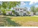 Charming two-story home with a well-manicured lawn, mature landscaping, and a classic white exterior at 4531 Lake Trudy Dr, St Cloud, FL 34769