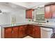 Modern kitchen featuring dark wood cabinetry, granite countertops, stainless steel appliances, and ample counter space at 4531 Lake Trudy Dr, St Cloud, FL 34769