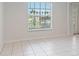 An empty living room features tile floors, neutral walls, and a doorway leading to the entry of the home at 4531 Lake Trudy Dr, St Cloud, FL 34769
