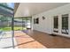 Covered and screened patio with tile flooring, adjacent to the pool and backyard at 4531 Lake Trudy Dr, St Cloud, FL 34769