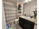 Bathroom with tile floors, dark cabinets, shower with curtain at 474 Annabelle Way, Davenport, FL 33837
