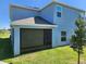 Exterior view of a modern two-story home featuring a screened-in porch and well-maintained lawn at 474 Annabelle Way, Davenport, FL 33837