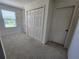 Upstairs hallway with a window for natural light and a large closet at 474 Annabelle Way, Davenport, FL 33837