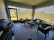 Relaxing screened lanai with comfortable seating, a ceiling fan, and an outdoor grill at 474 Annabelle Way, Davenport, FL 33837