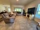 Open living room with comfortable seating and a large window for plenty of natural light at 474 Annabelle Way, Davenport, FL 33837