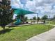 Community playground featuring a slide, swings, benches, and shade at 474 Annabelle Way, Davenport, FL 33837