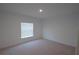 Bedroom with neutral carpet and large window with blinds at 4881 Vellacito Way, Davenport, FL 33897