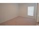 Bright bedroom features neutral carpet, a window with blinds, and a closet at 4881 Vellacito Way, Davenport, FL 33897