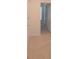 Hallway features neutral tile flooring and an entry to a bedroom with window at 4881 Vellacito Way, Davenport, FL 33897