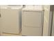 Laundry room features white washer, dryer, and wire shelving for storage at 4881 Vellacito Way, Davenport, FL 33897