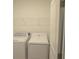 Laundry room features white washer, dryer, and wire shelving for storage at 4881 Vellacito Way, Davenport, FL 33897