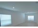 Bright living room featuring neutral tile flooring, a window, and ample natural light at 4881 Vellacito Way, Davenport, FL 33897