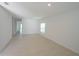 Bright living room featuring neutral tile flooring, a window, and ample natural light at 4881 Vellacito Way, Davenport, FL 33897